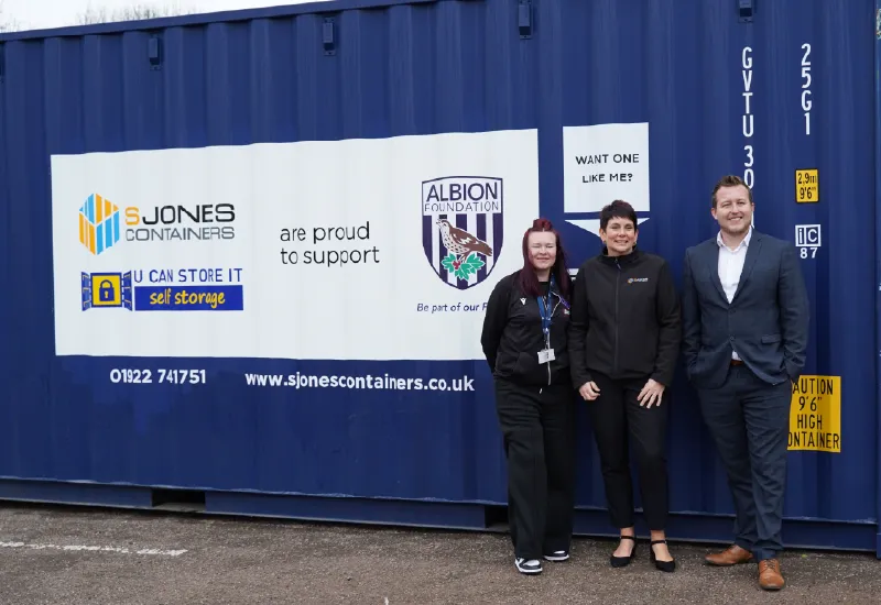 S Jones Containers team with Albion Foundation in front of branded charity shipping container supporting local community initiatives.