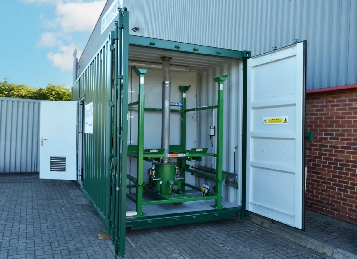 Open double doors of a green TransPAC container revealing neatly installed PAC dosing equipment inside, ready for operational use.
