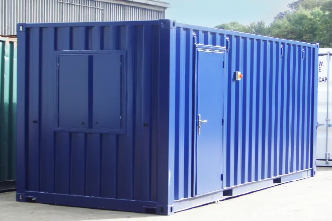 Blue 20ft steel shipping container converted into a secure office or welfare unit with window shutters and personnel door – durable and weatherproof.