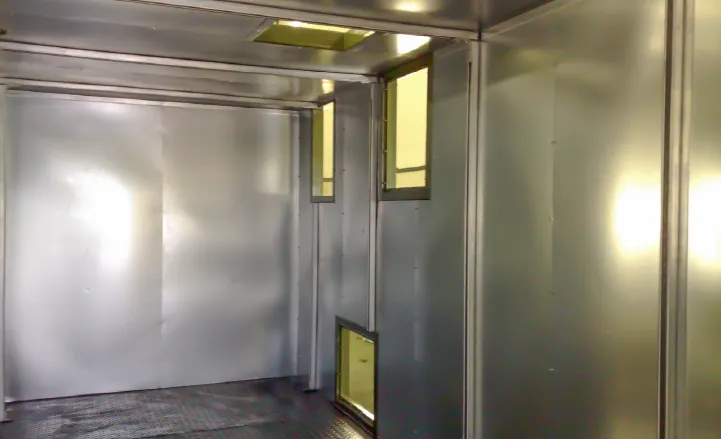 Inside view of a container boiler room showing smooth, metal-lined walls and ceiling for fire protection and insulation.